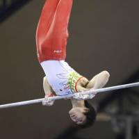 Kohei Uchimura competes on the horizontal bar at a gymnastics meet on Thursday in Doha. | KYODO