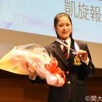 Satoko Miyahara, who finished fourth at the Pyeongchang Olympics, poses with the gold medal given to her by Kansai University president Keiji Shibai at a ceremony on March 8. | COURTESY PHOTO