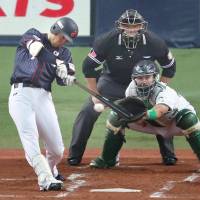 Japan\'s Shogo Akiyama connects on an RBI single during the second inning against Australia on Sunday night at Kyocera Dome. Japan won 6-0. | KYODO