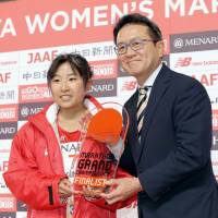 Hanami Sekine receives a trophy for qualifying for the Grand Championships, the qualifying race for Japanese runners for the 2020 Olympics, with a third-place finish at Sunday\'s Nagoya Women\'s Marathon. | KYODO