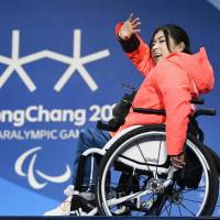 Momoka Muraoka waves to the crowd at the medal ceremony for the women\'s Alpine skiing super-G sitting category at the Pyeongchang Paralympics on Sunday. Muraoka took the bronze in the event. | KYODO