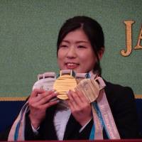 Sit skier Momoka Muraoka shows off five medals she earned at the Pyeongchang Paralympics during a news conference Wednesday at the Japan National Press Club in Tokyo. | NAOMI SCHANEN