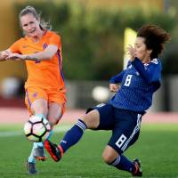 Desiree van Lunteren of the Netherlands (left) passes the ball ahead of Japan\'s Mana Iwabuchi during their game at the Algarve Cup in Parchal, Portugal, on Wednesday. | KYODO