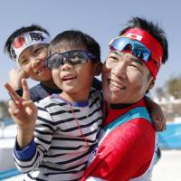 Yoshihiro Nitto celebrates with his two sons after winning silver in the men\'s cross-country 1.5-km sprint classical at the Pyeongchang Paralympics on Wednesday. | KYODO