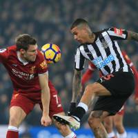 Liverpool\'s James Milner (left) and Newcastle\'s Kenedy vie for the ball during their match on Saturday in Liverpool, England. | AFP-JIJI