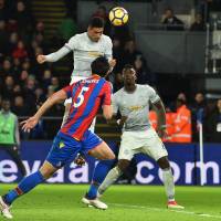 Manchester United\'s Chris Smalling heads the ball in for a goal against Crystal Palace in Premier League action at Selhurst Park on Monday night. | AFP-JIJI