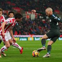 Manchester City\'s David Silva controls the ball on Monday against Stoke City.  Silva had a pair of goals in the visitors\' 2-0 win. | REUTERS