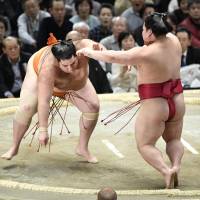 Kaisei (left) defeats Daieisho on Friday at the Spring Grand Sumo Tournament in Osaka. Kaisei improved to 6-0. | KYODO