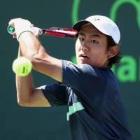 Yoshihito Nishioka plays a shot in the first round of the Miami Open on Thursday. Nishioka defeated Alex De Minaur in straight sets. | GETTY / KYODO