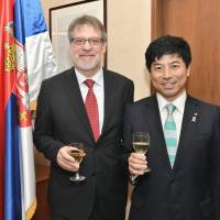 Serbian Ambassador Nenad Glisic (left) joins State Minister for Foreign Affairs Kazuyuki  Nakane during a reception to celebrate the country\'s national day at the embassy on Feb. 15. | YOSHIAKI MIURA