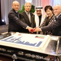 Kuwaiti Ambassador Abdul Rahman Humood Al-Otaibi (center) cuts a cake with (from left) Parliamentary Vice-Minister for Foreign Affairs Manabu Horii, Japan-Kuwait Parliamentary Friendship League Chairman Eisuke Mori, Tokyo Gov. Yuriko Koike and Manlio Cadelo, dean of the Diplomatic Corps, during a reception to celebrate the country\'s national day at Palace Hotel on Feb. 22. | YOSHIAKI MIURA