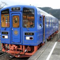 Wakasa Railway Co. unveils its Showa train car on Thursday, inviting railway fans for a test ride in Wakasa, Tottori Prefecture. The train, designed in the classic style of the Showa Era, will start daily operations on Sunday. | KYODO