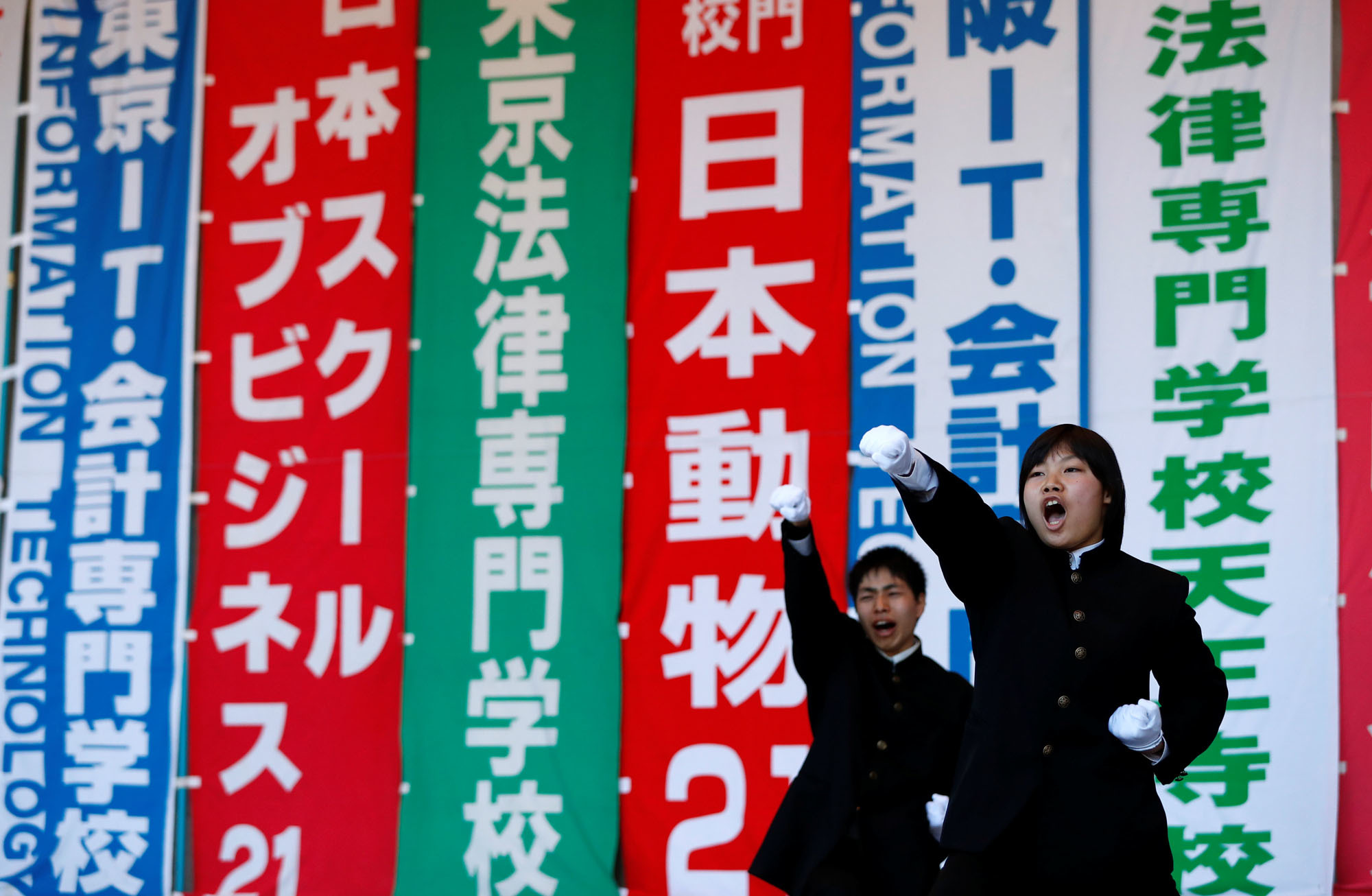 Members of a cheering squad encourage college students at a pep rally in Hibiya Park, Tokyo, on Thursday intended to boost morale ahead of the job-hunting season &#8212; which remains fiercely competitive despite a 'labor crunch.' | REUTERS