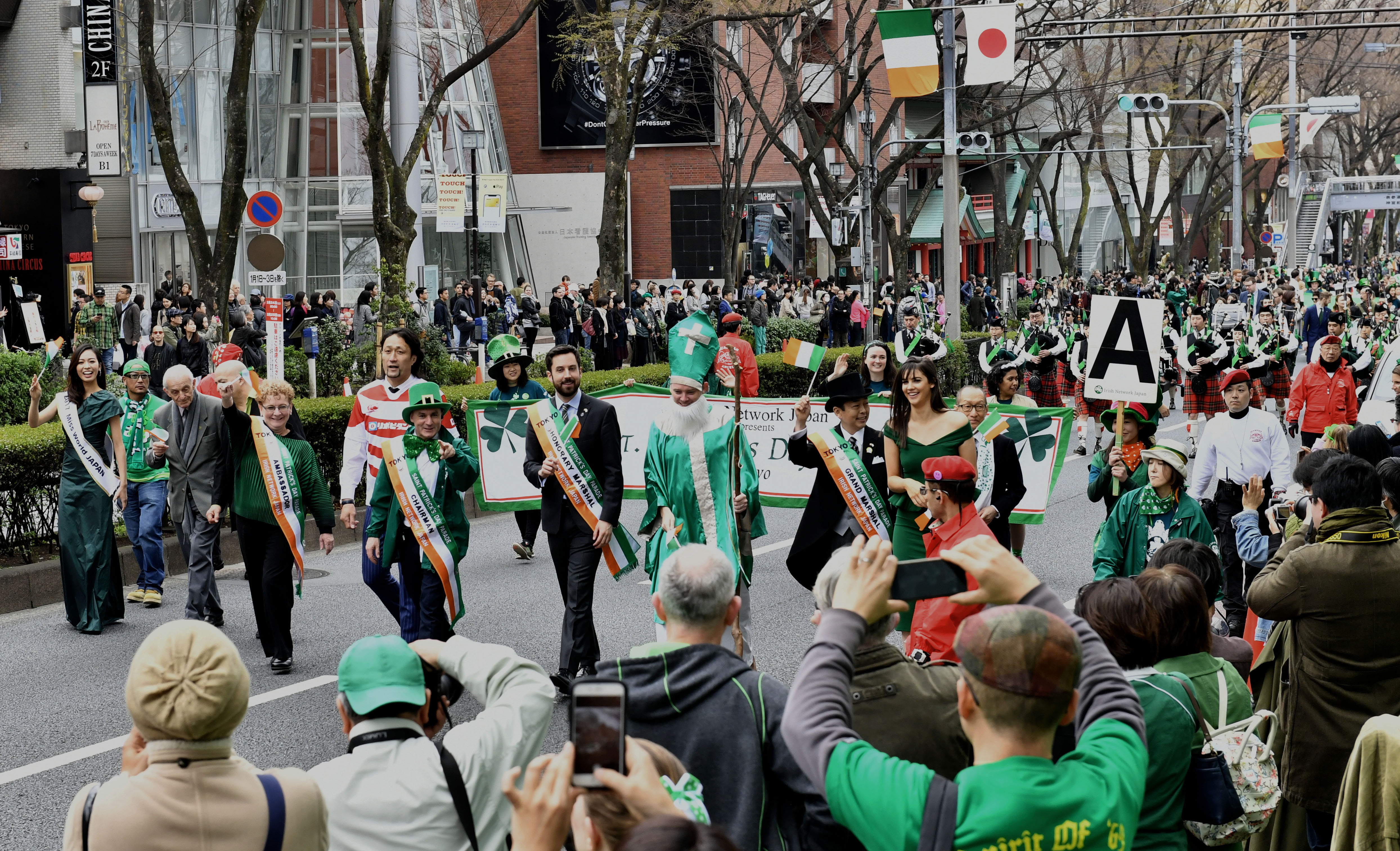 People dressed in green walk along Omotesando Dori Avenue in Tokyo during the annual St. Patrick's Day Parade on Sunday. About 1,500 people participated in the event and an estimated 30,000 watched. | YOSHIAKI MIURA