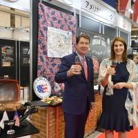U.S. Ambassador to Japan William Hagerty (left) and his wife, Chrissy Hagerty, pose at the U.S. Pavilion of the  Foodex Japan 2018 food trade show Tuesday at Makuhari Messe in Chiba Prefecture. The pavilion features 53 U.S. companies and organizations such as the U.S. Meat Export Federation and includes booths for visitors to sample American products. | YOSHIAKI MIURA