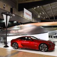 Toyota Motor Corp.\'s Lexus Sport Yacht Concept looms over a Lexus LC 500 at the Japan International Boat Show in Yokohama on March 8. Toyota\'s premium brand plans to start selling a 65-foot (20-meter) ultra-luxury yacht in the United States in the second half of 2019 as part of its strategy to sell more cars and catch up to its rivals. | BLOOMBERG