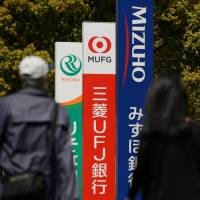 Japanese banks are now diving into digital payments thanks to a regulatory change that threatens to usher in new rivals. | BLOOMBERG