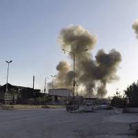 This photo released by the Syrian Civil Defense White Helmets that has been authenticated based on its contents and other AP reporting, shows smoke rising after Syrian government airstrikes hit in the town of Douma, in eastern Ghouta east of Damascus Saturday. | SYRIAN CIVIL DEFENSE WHITE HELMETS / VIA AP