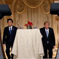 U.S. President Donald Trump and Prime Minister Shinzo Abe arrive for a joint news conference at Trump\'s Mar-a-Lago estate in Palm Beach, Florida, on Wednesday. | REUTERS