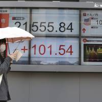 A stock board at a securities firm in Tokyo shows the latest figures Monday. | AP