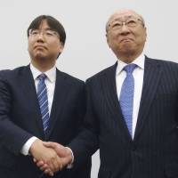 Shuntaro Furukawa (left) and Tatsumi Kimishima attend a news conference in Osaka on Thursday. | BLOOMBERG