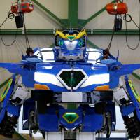 The J-deite Ride robot, which can turn into a car,is unveiled at a factory near Tokyo on Wednesday. | REUTERS
