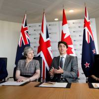 Canadian Prime Minister Justin Trudeau gestures in a meeting with British Prime Minister Theresa May (second from left), New Zealand Prime Minister Jacinda Ardern (right) and Australian Prime Minister Malcolm Turnbull at the National Cyber Security Center in London Wednesday. | SEAN KILPATRICK / THE CANADIAN PRESS / VIA AP