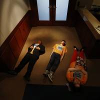 High school students hold a \"die-in\" in front of Gov. Doug Ducey\'s office in a protest against gun violence on Friday in Phoenix. | AP