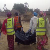 Rescue workers carry the body of a victim following a suicide attack in Maiduguri, Nigeria, Monday. Nigeria\'s Boko Haram Islamic extremists attacked two villages on the outskirts of the northeastern city of Maiduguri late Sunday. | AP