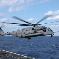 A CH-53E helicopter, assigned to the 1st Marine Aircraft Wing, takes off from the flight deck of the amphibious transport dock ship USS Green Bay during an exercise off Okinawa Prefecture in November 2016. | NAVY MEDIA CONTENT SERVICES