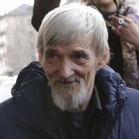 Historian Yuri Dmitriev speaks Thursday outside a court building in Petrozavodsk, Russia. | REUTERS