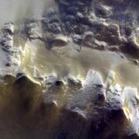 In this image provided by the European Space Agency, ESA, the ExoMars Colour and Stereo Surface Imaging System, CaSSIS, captured this view of the rim of Korolev crater (73.3ºN/165.9ºE) on April 15. The European Space Agency has released its first image taken by a probe orbiting Mars, showing the ice-covered edge of a vast crater. Scientists combined three pictures taken by the Trace Gas Orbiter\'s camera instrument, CaSSIS, from an altitude of 400 km (249 miles) on April 15. | ESA/ROSCOSMOS / CASSIS / VIA AP