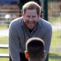 Britain\'s Prince Harry plays with children during a visit to a \'Fit and Fed\' school holiday activity program at the Roundwood Youth Centre in London in February. | REUTERS
