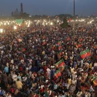 Supporters of opposition leader Imran Khan\'s party, Tehreek-e-Insaf, attend a rally in Lahore, Pakistan. Tens of thousands of supporters of the popular opposition lawmaker who hopes to become Pakistan\'s prime minister have gathered in the eastern city of Lahore as his political party launched its campaign for July elections. | AP