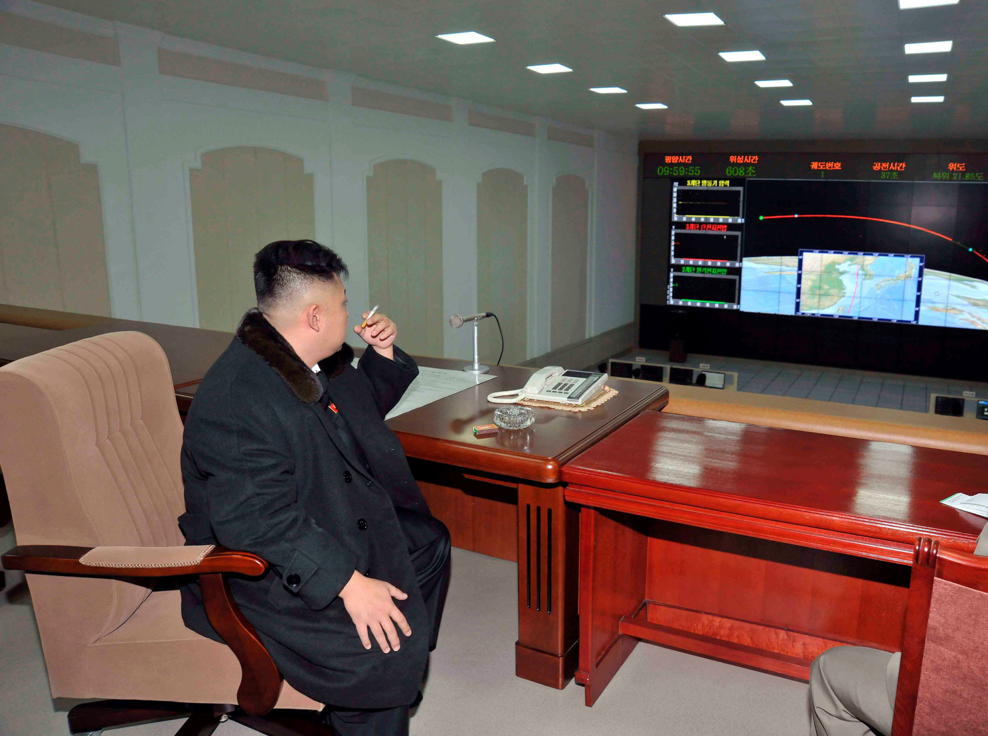 North Korean leader Kim Jong Un smokes a cigarette at the General Satellite Control and Command Center following the launch of the Unha-3 rocket at West Sea Satellite Launch Site in North Pyongan province in December 2012. | REUTERS
