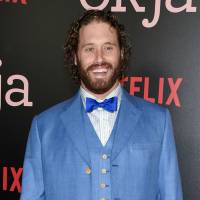 Actor T.J. Miller attends the premiere of Netflix\'s \"Okja\" in New York last June. Miller was arrested Monday night at LaGuardia Airport in New York and charged with calling 911 to falsely claim that a woman on the same train as him had a bomb in her luggage. Prosecutors said Miller called in the false bomb information on March 18 after getting into a verbal confrontation with a woman on a train traveling from Washington D.C. to New York. | EVAN AGOSTINI / INVISION / VIA AP