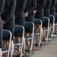 New female employees of Japan Airlines Co. attend an initiation ceremony in a hangar at Haneda Airport in Tokyo on April 2. The U.S. State Department expressed concern Friday about sexual harassment in Japan, saying it remained \"widespread\" in the workplace, in an annual rights report. | BLOOMBERG