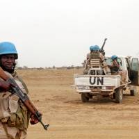 U.N. peacekeepers stand guard in the northern town of Kouroume, Mali, in 2015. Kourome is 18 km (11 miles) south of Timbuktu. | REUTERS