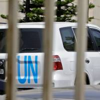 United Nations vehicles are seen outside the hotel where the international experts from the Organization for the Prohibition of Chemical Weapons (OPCW) are staying in Damascus on Thursday. U.N. security experts have said they were negotiating with Syrian and Russian authorities for international chemical inspectors to deploy to the site of an alleged toxic gas attack near Damascus, after a reconnaissance mission came under fire. The team from the world\'s chemical arms watchdog has not yet been able to begin its field work in Douma, where dozens were killed in a suspected April 7 gas attack, as Western powers warn that President Bashar Assad\'s regime may attempt to remove crucial evidence. | AFP-JIJI