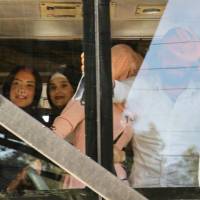 Syrian refugees evacuated from the southern Lebanese village of Shebaa ride in a bus through the Masnaa crossing on the Lebanon-Syria border leading to Damascus on Wednesday to return home to their village of Beit Jinn in the southwestern Damascus countryside. | AFP-JIJI