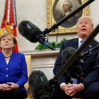U.S. President Donald Trump meets with German Chancellor Angela Merkel in the Oval Office of the White House on Friday. | REUTERS