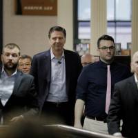 Former FBI Director James Comey (second, left) arrives to speak about his book \"A Higher Loyalty\" in New York Wednesday. | REUTERS