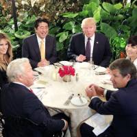 Prime Minister Shinzo Abe and U.S. President Donald Trump attend dinner with their wives at the Mar-a-Lago Club in Palm Beach, Florida, in February 2017. | REUTERS / VIA KYODO