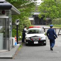 Police officers guard the Imperial Palace\'s Hanzomon gate in April. | YOSHIAKI MIURA