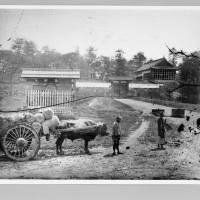People with an ox cart walk in front of Edo Castle\'s Hanzomon gate in 1871.  courtesy of edo-tokyo museum | COURTESY OF EDO-TOKYO MUSEUM