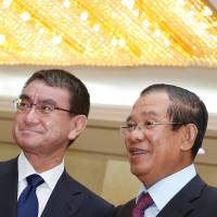 Foreign Minister Taro Kono and Cambodian Prime Minister Hun Sen get together for a meeting in Phnom Penh on Sunday. | REUTERS