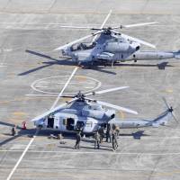 A U.S. military UH-1 helicopter (front) made an emergency landing at Kumamoto Airport on Wednesday. | KYODO