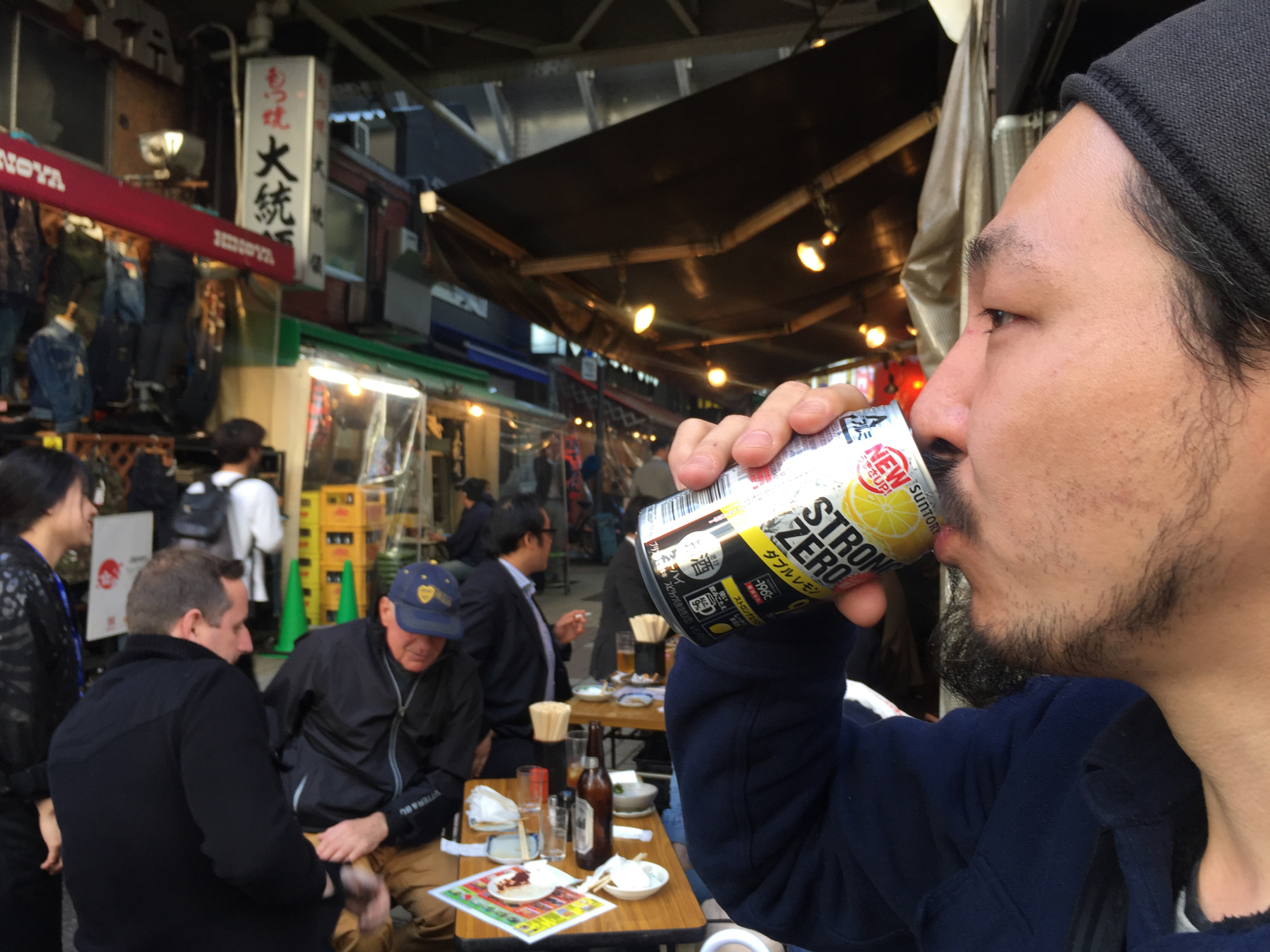 Shigehito Inoue sips a can of Suntory's top-selling Strong Zero in Tokyo's Ueno district, in April. Major brewing and distilling companies are betting on chūhai to offset over a decade of shrinking beer sales. | ALEX MARTIN