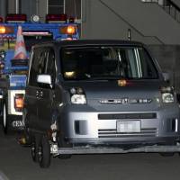 A stolen car believed to have been used by escaped prisoner Tatsuma Hirao sits on a trailer Monday at a police station in Imabari, Ehime Prefecture. | KYODO
