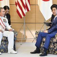 Adm. Harry Harris (left), commander of U.S. Pacific Command, meets Prime Minister Shinzo Abe on Thursday at the Prime Minister\'s Office. The two agreed to maintain maximum pressure on North Korea to abandon its nuclear and ballistic missile development programs. | KYODO